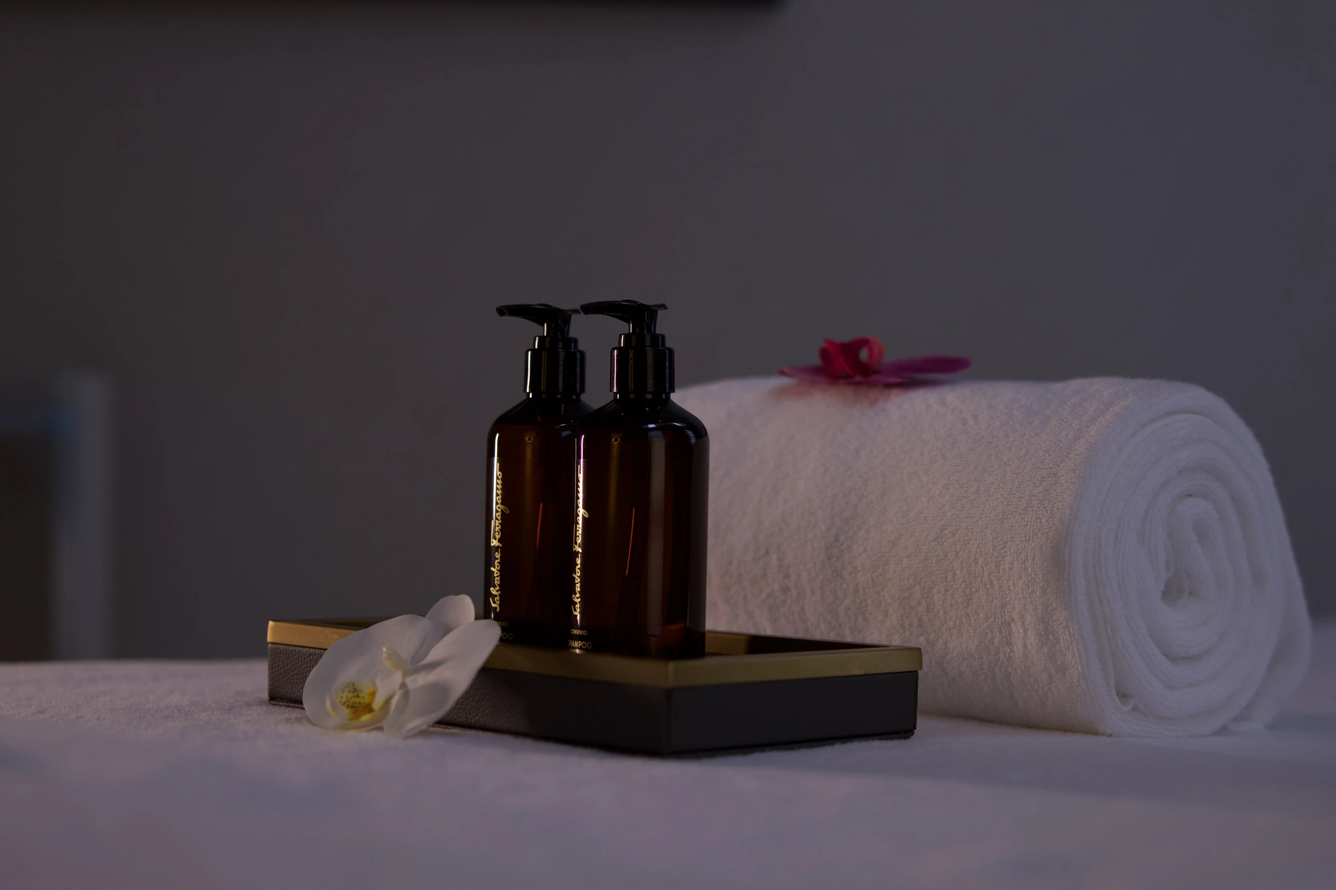 Amenities and a rolled towel on a treatment table at the spa, Sariya Hotel